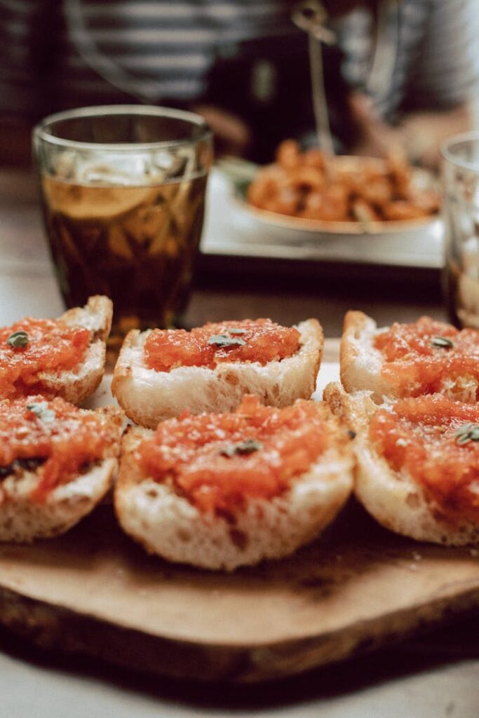 pexels photo 3793871 Close-up of delicious Catalan tomato bread with drinks in a cozy Barcelona cafe setting.